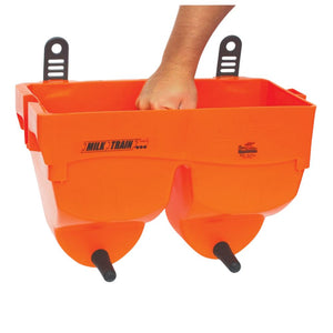 Orange milk train feeder held by a hand on a white background
