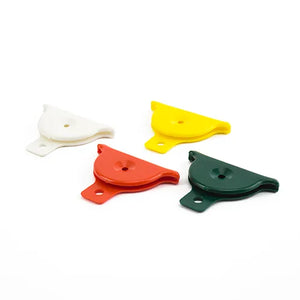 Four colorful plastic dog whistles on a white background