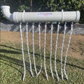 White cattle pest control device with multiple wicks on a grassy area