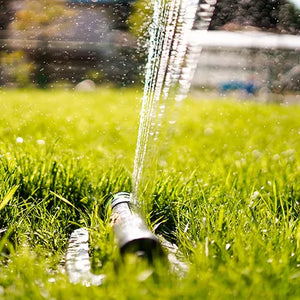 Sprinkler watering grass with a blurred background