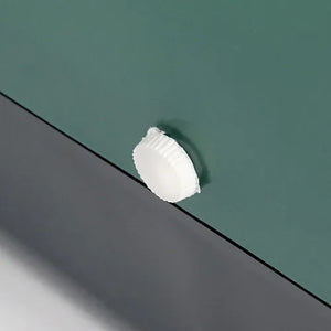 White lug on a green nesting box with a black floor below