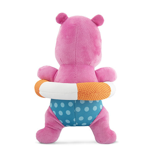 Pink plush toy with a white polka dot swimsuit and orange and white striped swim ring on a white background