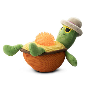 Plush turtle toy with an orange ball on a white background