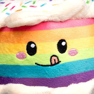 Plush toy with rainbow stripes and a smiling face on a white background