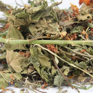 Close-up of dried herbs and leaves on a white surface