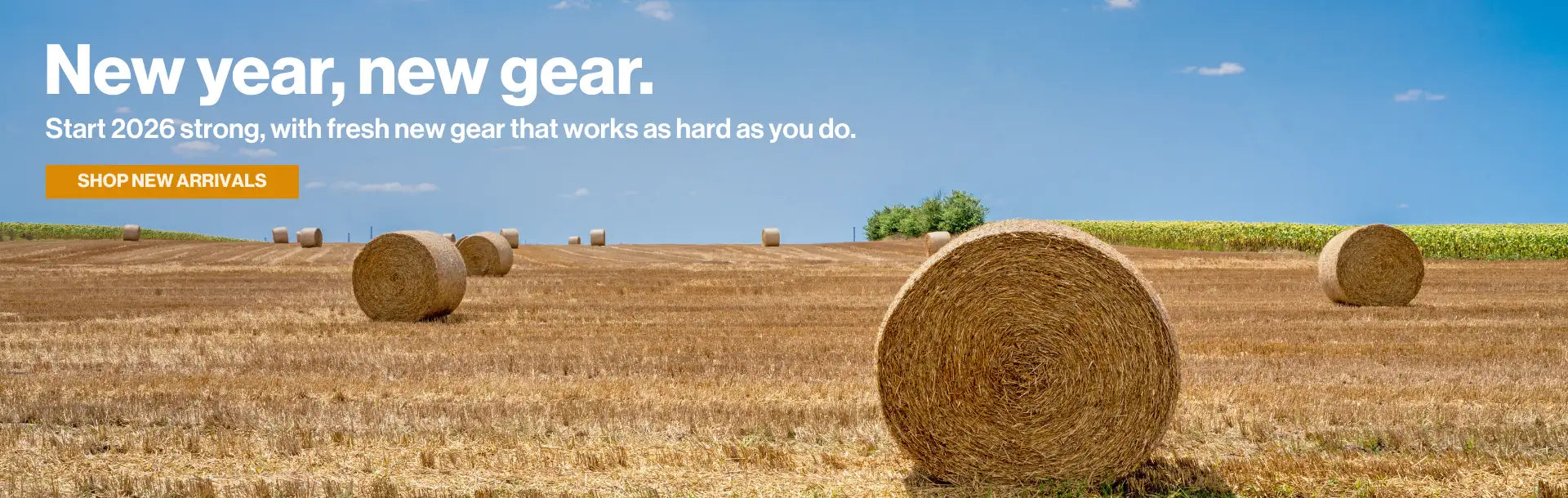 Hay bales in a field with a promotional banner for new year, new gear.