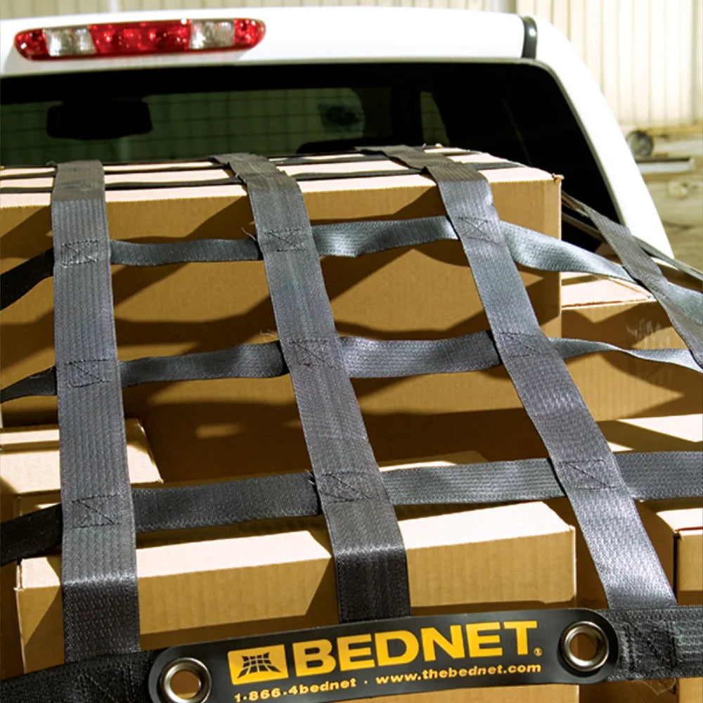 A cargo net securing boxes in the back of a white truck, representing the use of the product for securing loads on a vehicle.