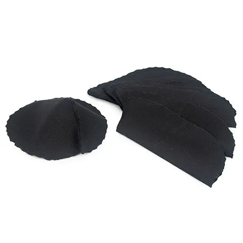 A stack of black livestock pink-eye patches on a white background