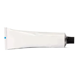 White tube of pink-eye patch adhesive with black cap on a white background