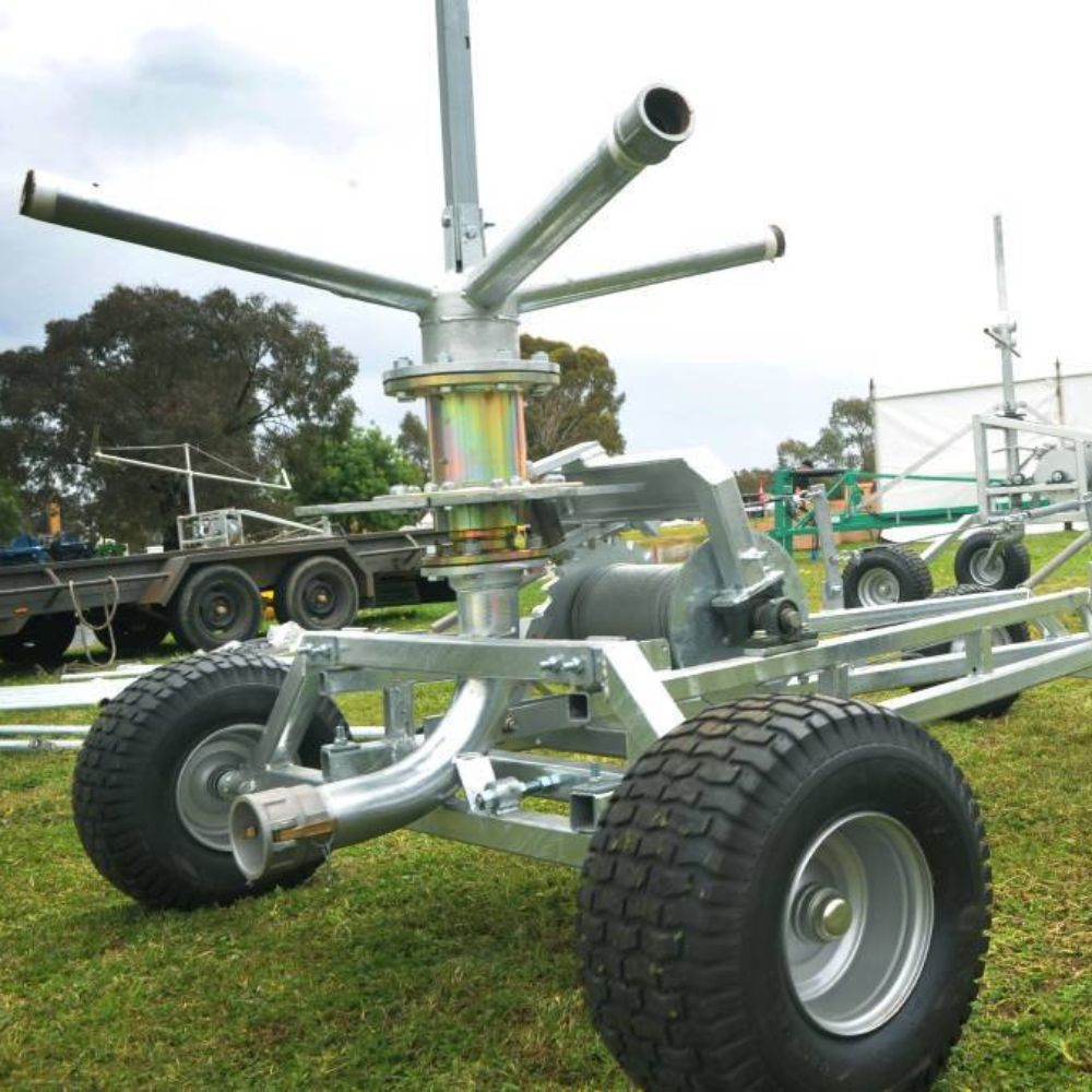 Farm irrigator system with trees in the background