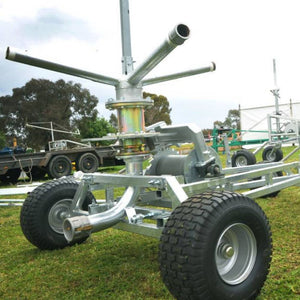 Farm irrigator system with trees in the background
