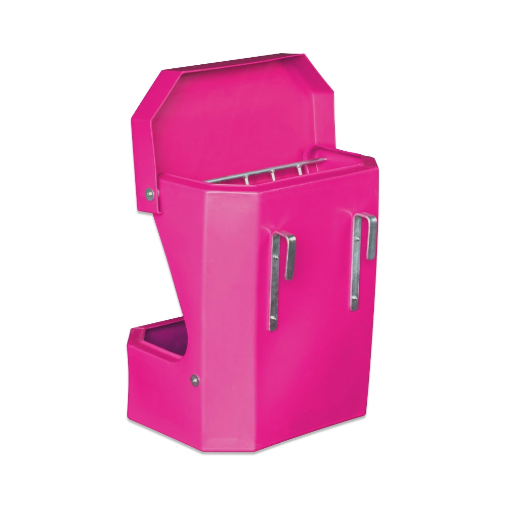 Pink plastic horse feeder for filling with hay with a white background