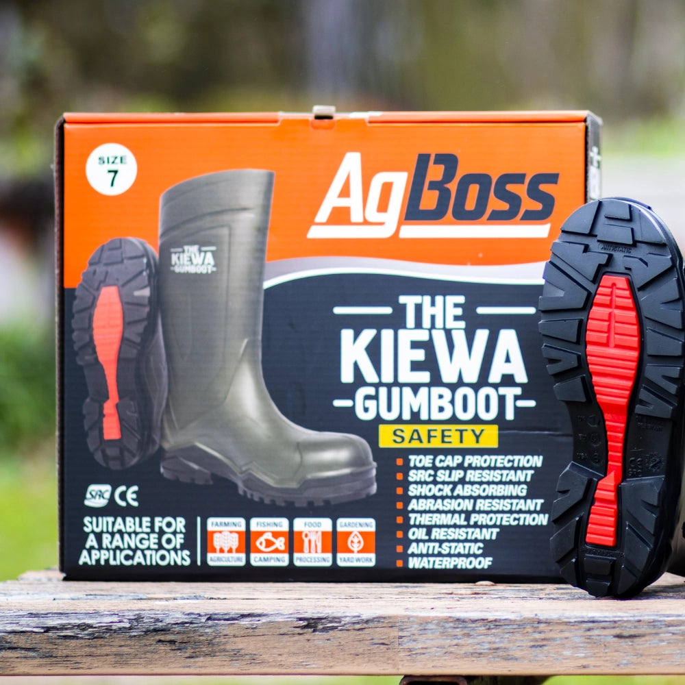 AgBoss Kiewa Gumboot safety boot packaging on a wooden surface with a blurred natural background