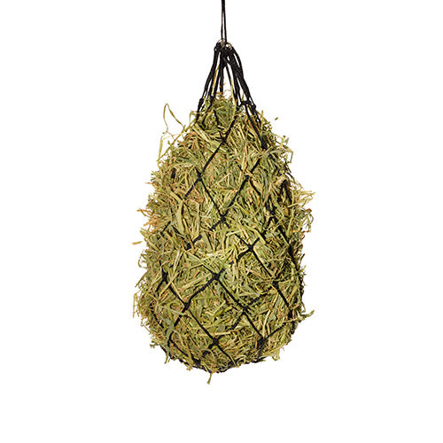 Hay net filled with hay hanging against a white background
