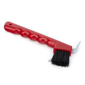 A red hoof pick with a brush attached to the handle, used for cleaning horse hooves.