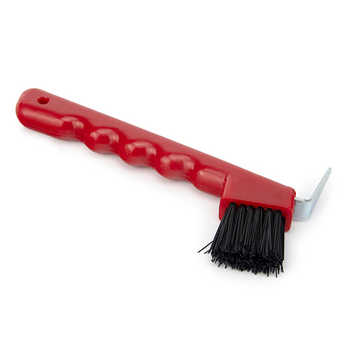 A red hoof pick with a brush attached to the handle, used for cleaning horse hooves.
