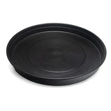 Black round chicken feeding tray with textured surface on a white background