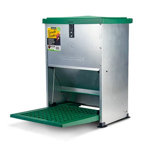 Metal and plastic chicken feeder with green top and green treadle platform on a white background