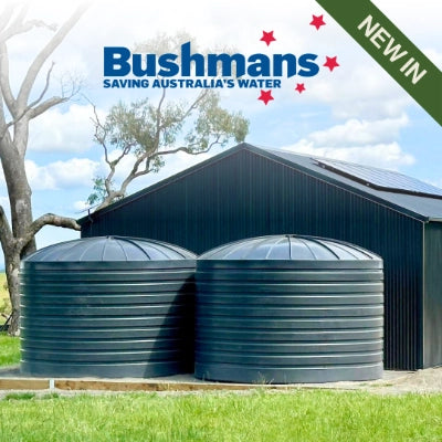 Two large cylindrical tanks with a building and tree in the background, featuring Bushmans branding.